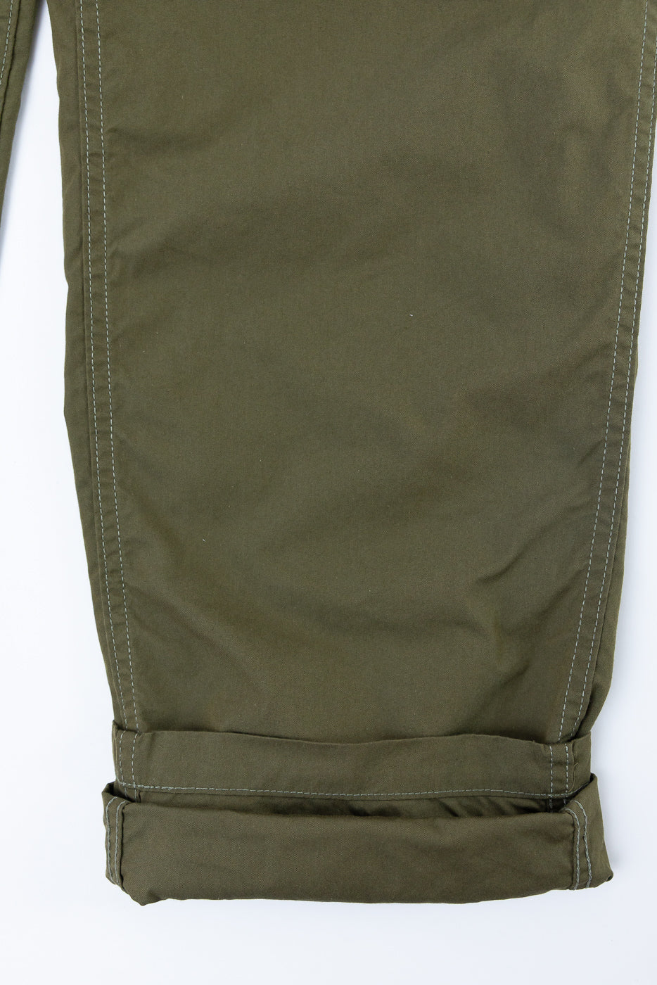 Olive green pants flat lay, front view, cuffed hem with contrast stitching