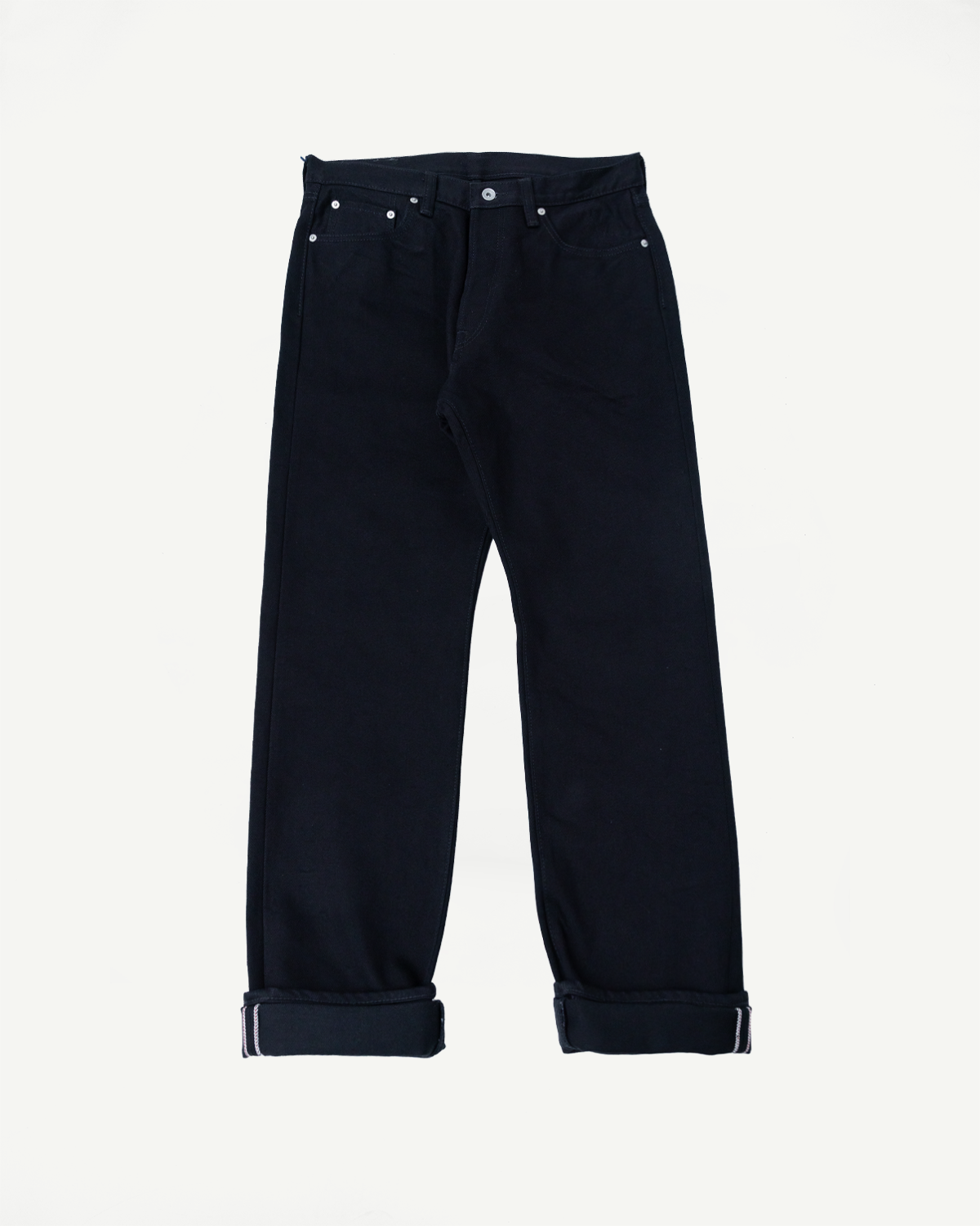 Front view of dark selvedge jeans with cuffed hems, silver buttons, and classic stitching details