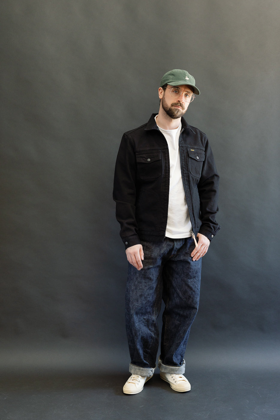 IHJ-123-OD - 14oz Broken Twill Selvedge Denim Work Jacket - Indigo Overdyed Black, worn by a 5'9 Caucasian male, styled with rolled-cuff dark jeans and off-white sneakers.