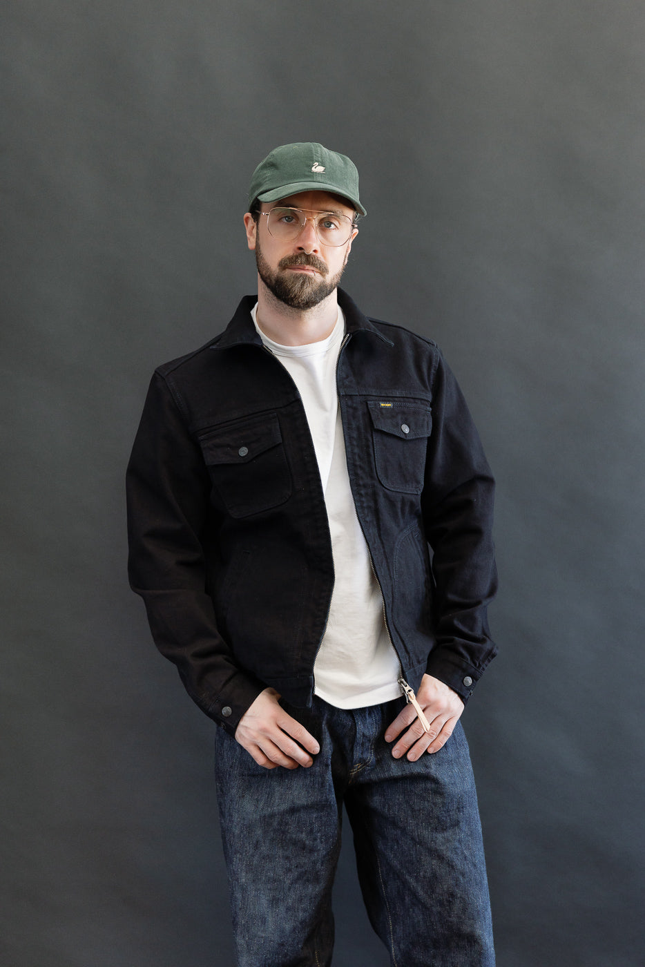 IHJ-123-OD - 14oz Broken Twill Selvedge Denim Work Jacket - Indigo Overdyed Black, worn by a model in a black denim jacket with metal buttons, showcasing its casual, stylish design.