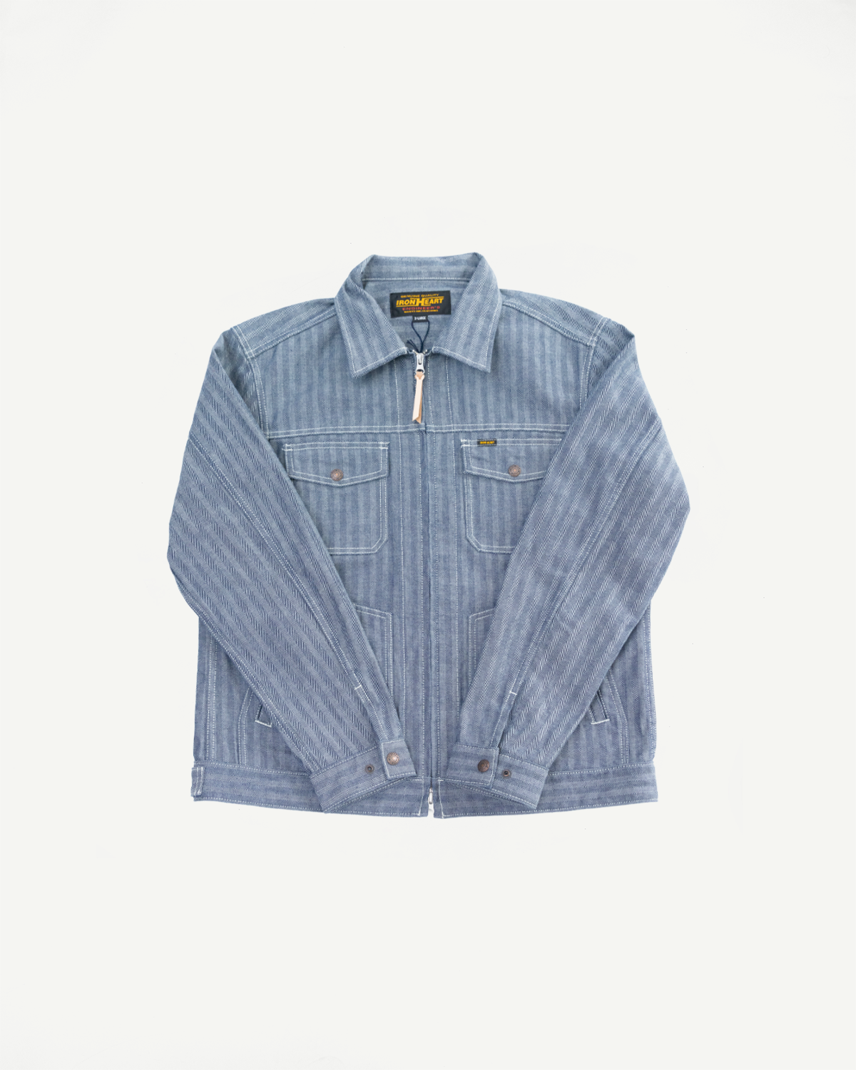 Flat lay of indigo herringbone work jacket, front view showing zip closure, chest pockets, and collar.