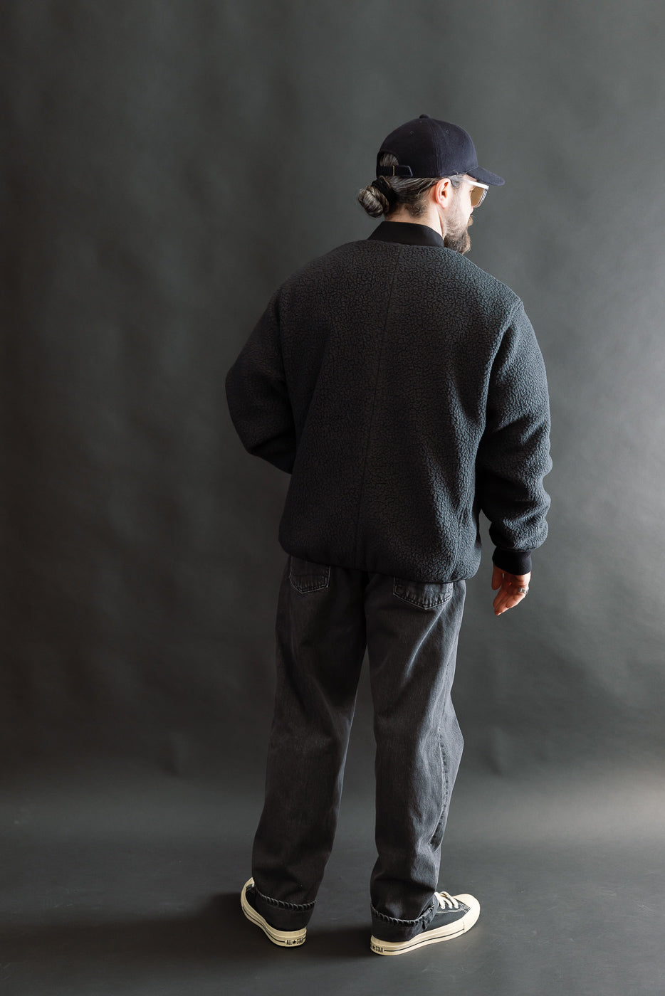 Full body, back view of male model 5'9