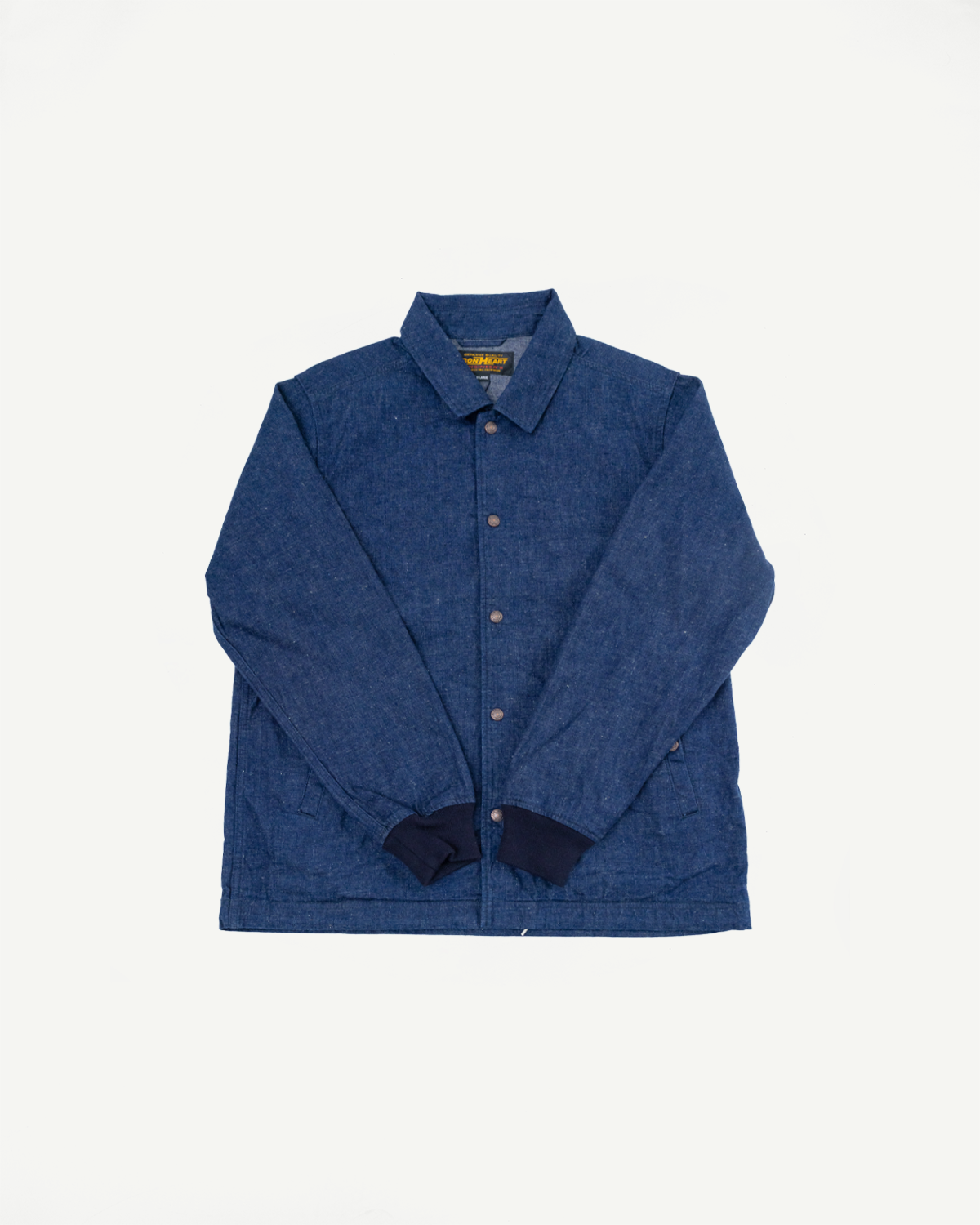 Front view of blue chambray shirt with button closure, collar, and contrast cuffs, flat lay