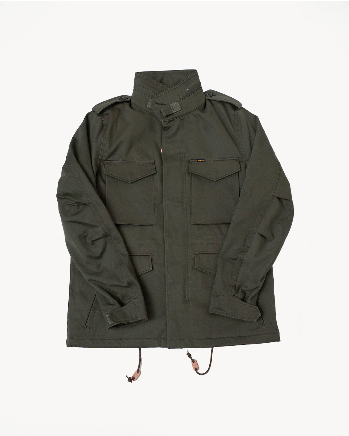 Front flat lay of olive Iron Heart IH M-65 field jacket, showing pockets, epaulets, and drawstring hem