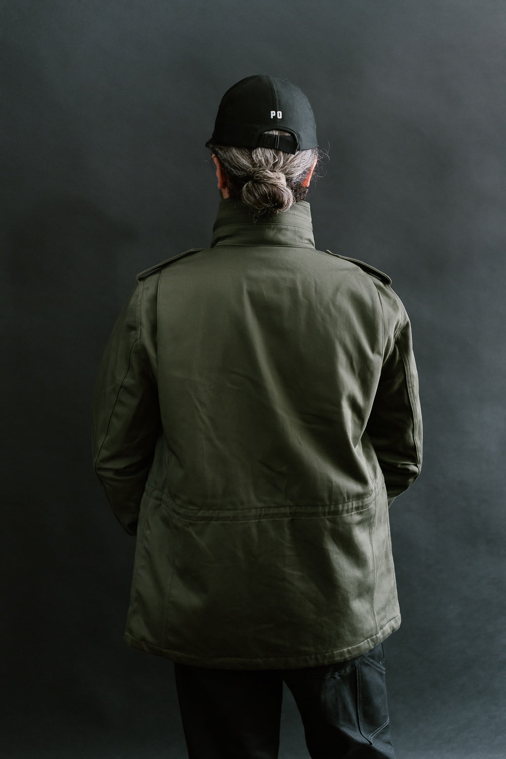 Back view of Iron Heart olive M65 field jacket on male model, 5'9