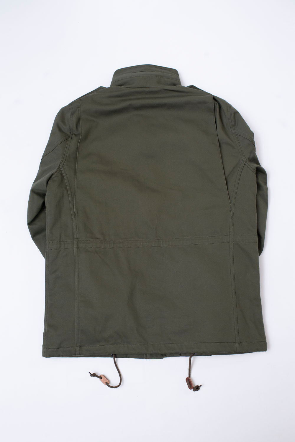 Flat lay of Iron Heart olive sateen M65 field jacket, back view, showing drawstring hem