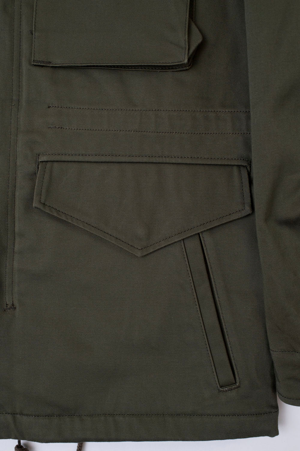 Close-up of front lower pockets and fabric detail on olive Iron Heart M65 Field Jacket