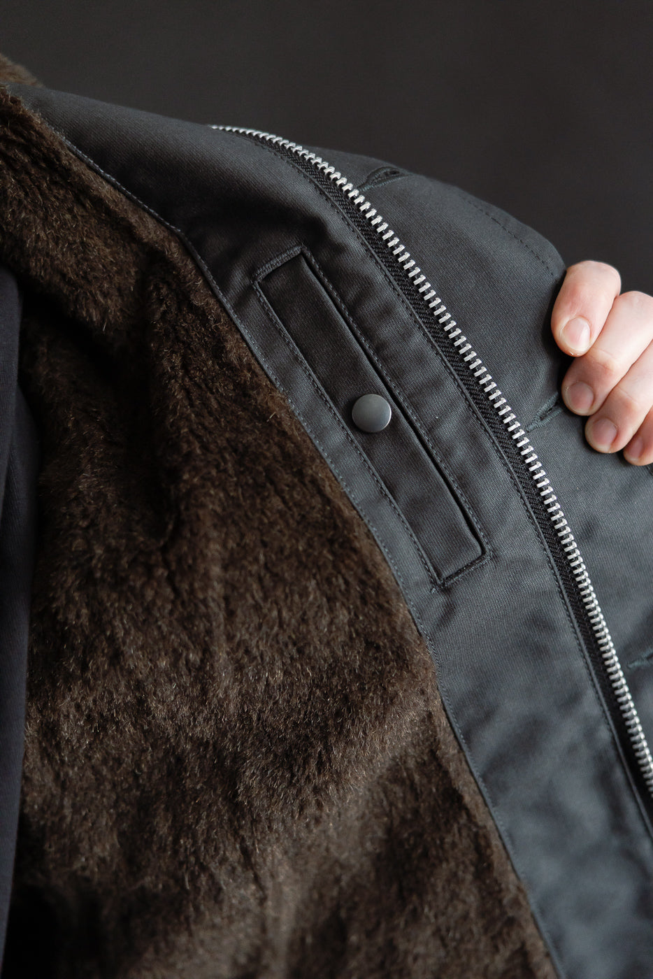 Close-up of Iron Heart black N1 Deck Jacket interior, showing brown faux fur lining, snap pocket, and metal zipper at Dant contemporary casual apparel.