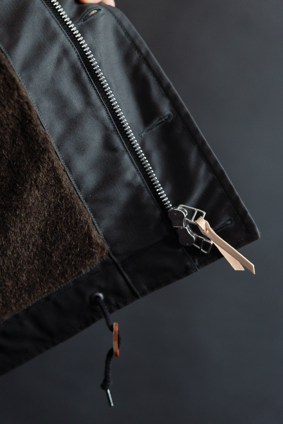 Close-up of Iron Heart N1 Deck Jacket black whipcord showing front zipper, drawstring, and wool lining