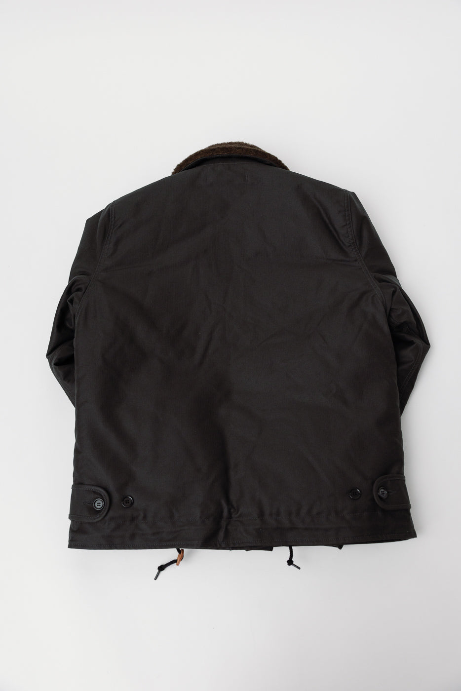 Flat lay of Iron Heart N1 Deck Jacket in black, back view, showing hem, buttons, and collar detail.