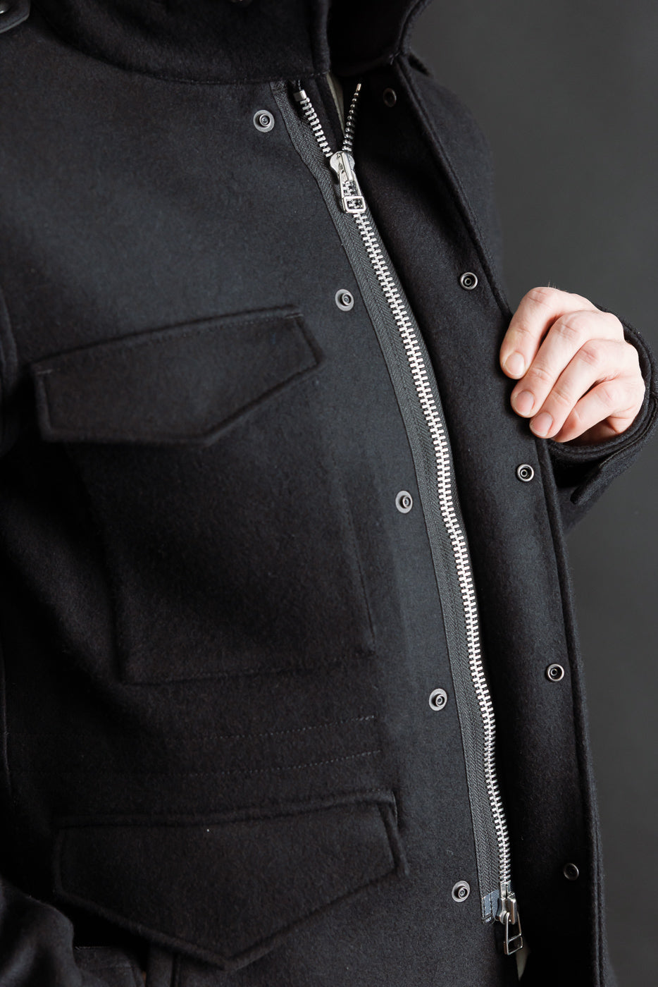 Close-up of Iron Heart black 21oz Melton wool M65 field jacket front chest, zipper, and pockets on male model, 5'9
