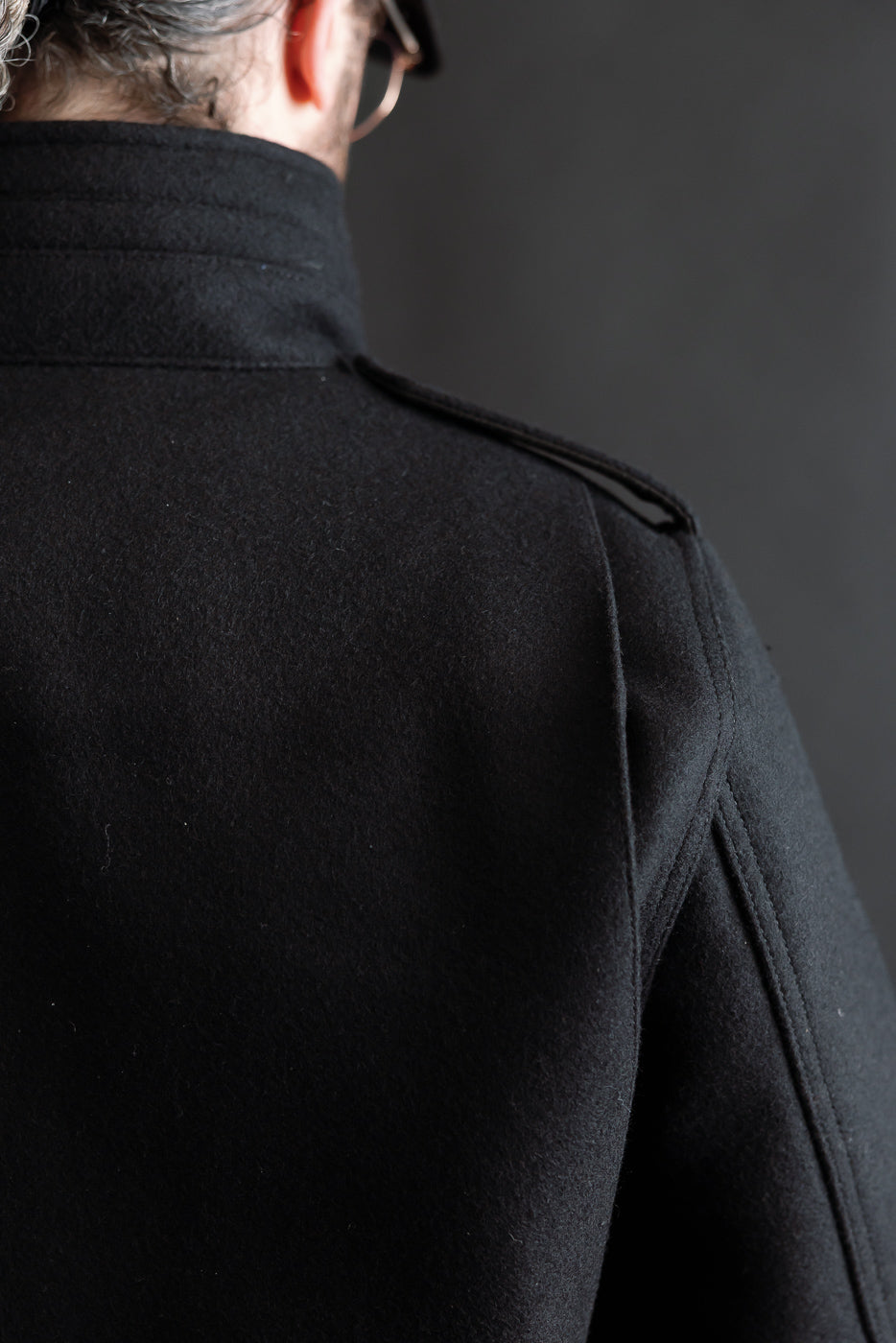 Close-up back view of Iron Heart 21oz Melton wool M65 black jacket, collar and shoulder detail, on male model 5'9
