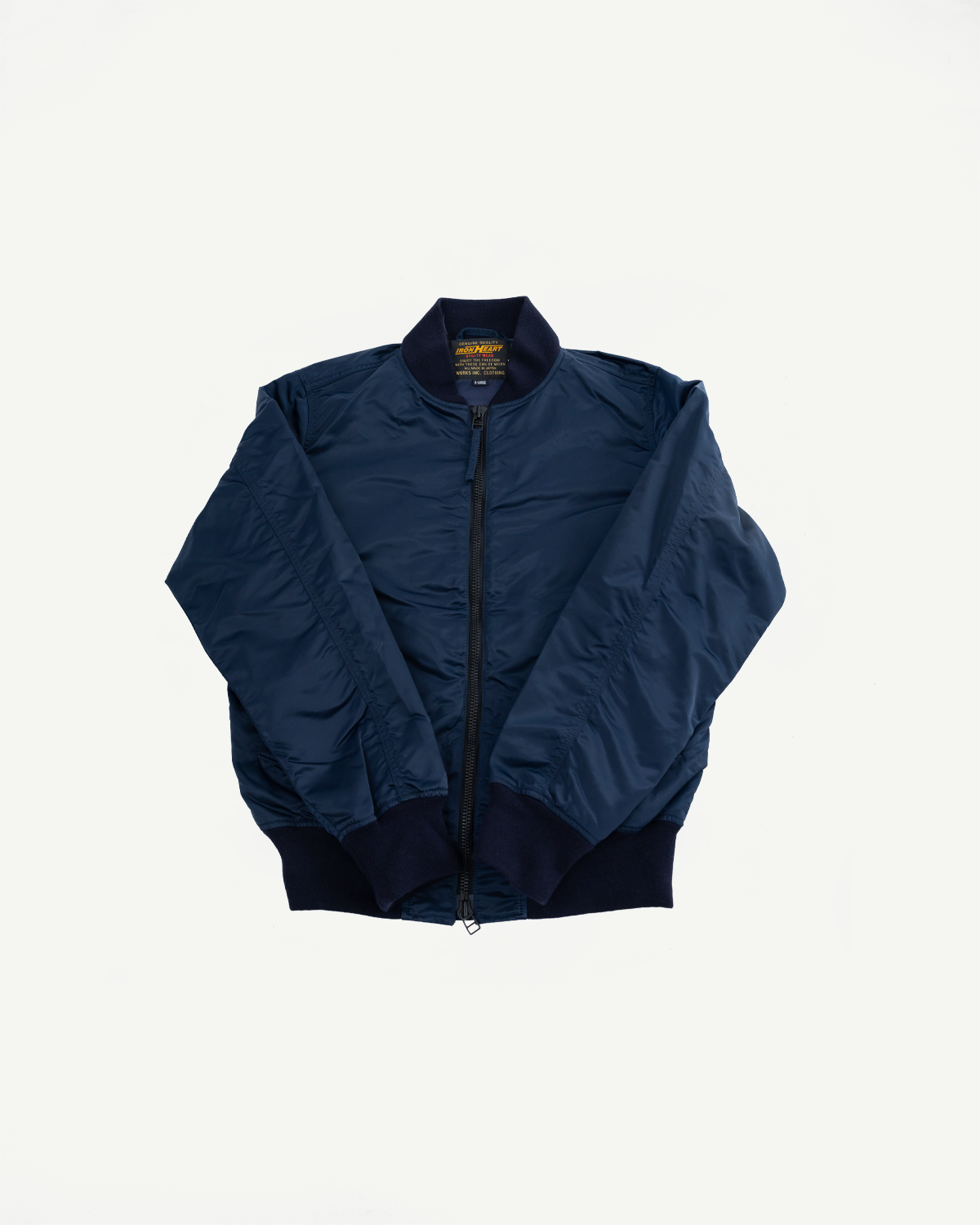 Flat lay front view of navy nylon Type L-2B jacket, showing zipper, ribbed collar, cuffs, and hem.