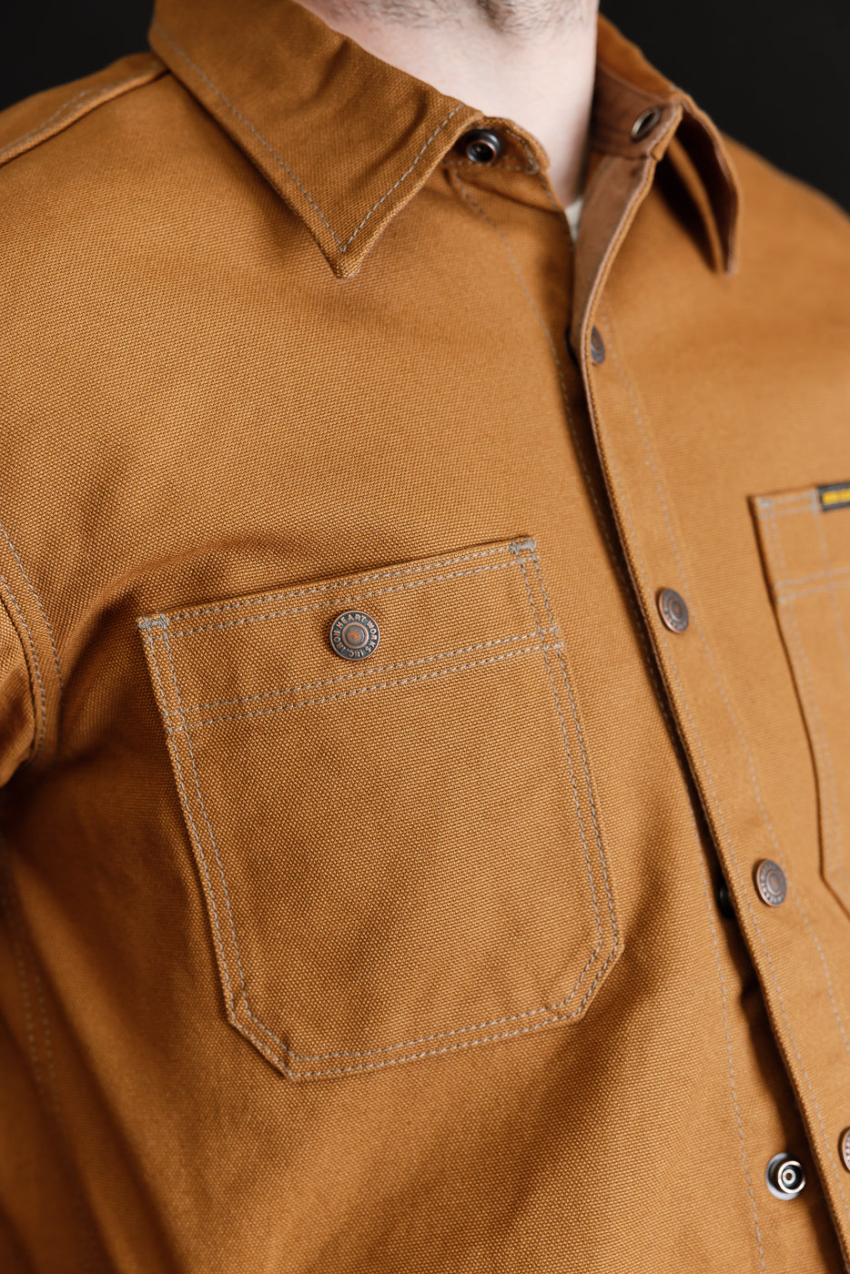 Close-up of front chest and collar on male model, 5'9