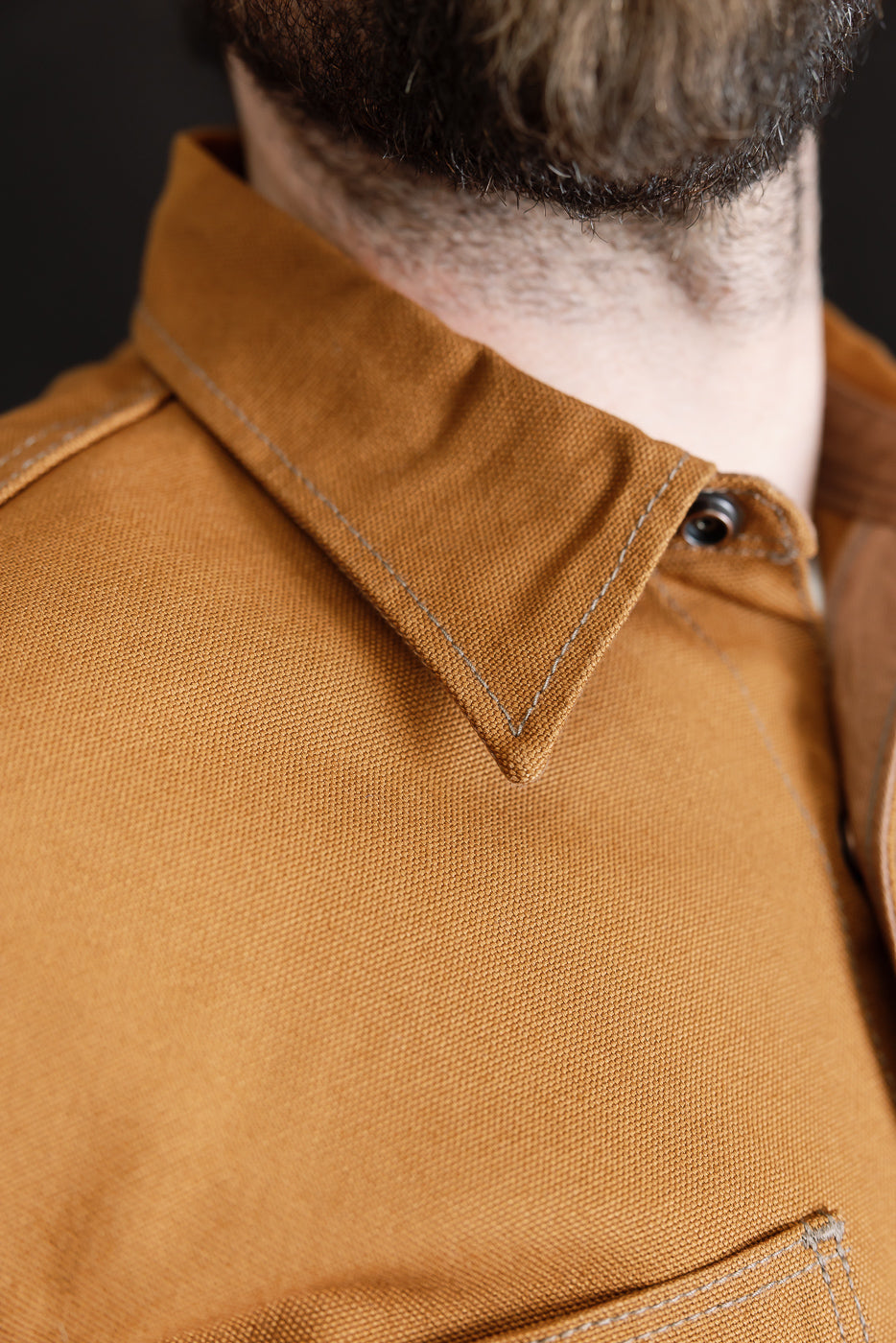 Close-up of brown duck canvas work shirt collar, front view, on male model 5'9