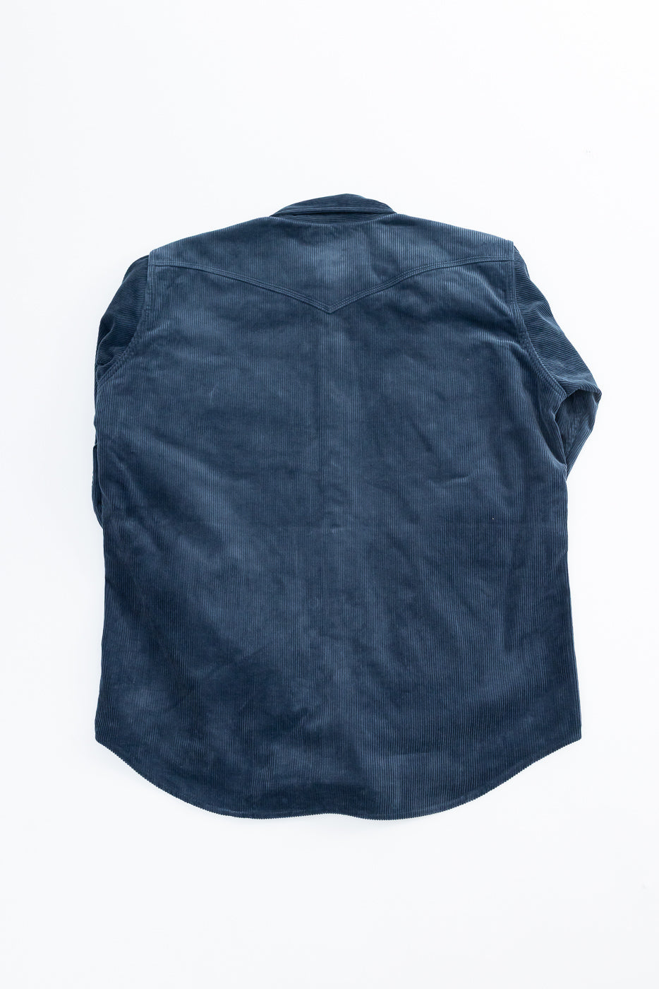 Back view flat lay of navy corduroy shirt with yoke detail, short sleeves, curved hem