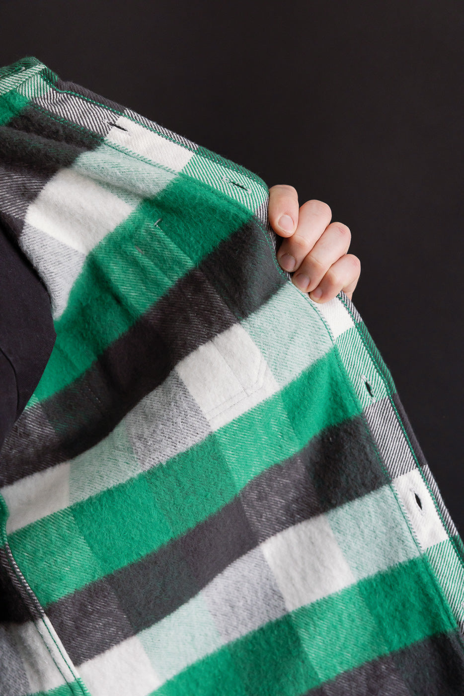 Close-up of Iron Heart IHSH-428 green ultra heavy flannel overshirt front fabric texture, showing buttonholes and plaid pattern at Dant contemporary casual apparel.