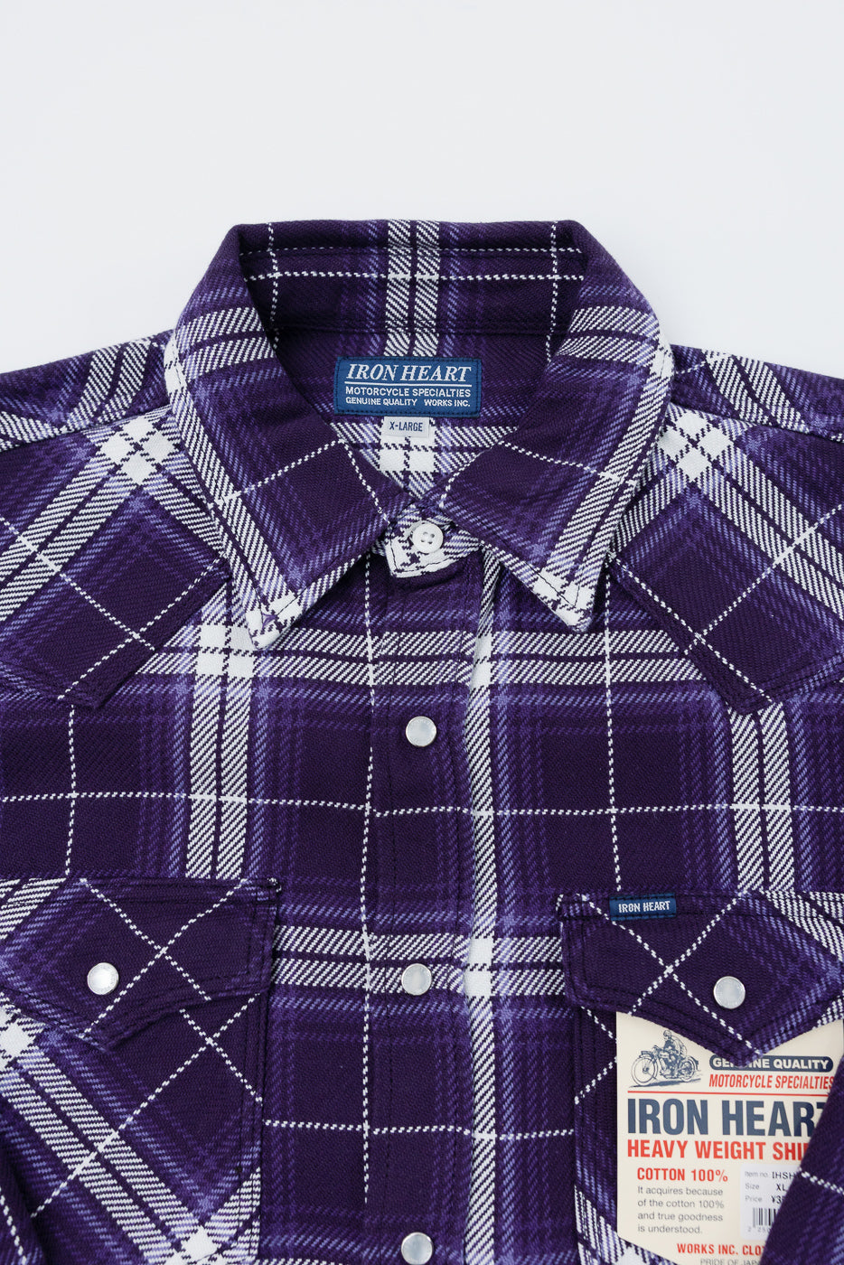 Purple plaid shirt close-up, front view, showing collar, buttons, and Iron Heart tag details.