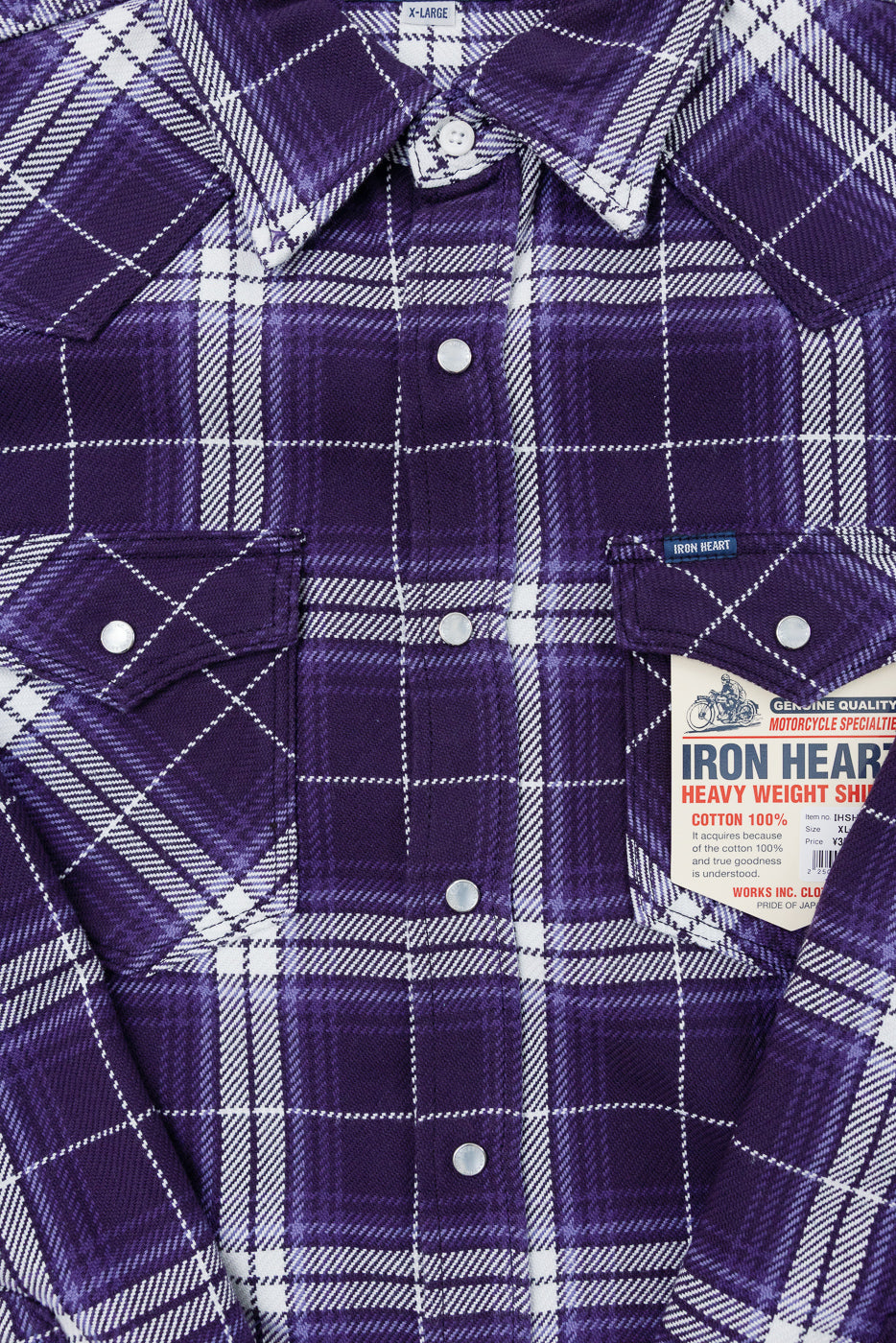 Purple plaid shirt front close-up, showing buttons, collar, and tag details