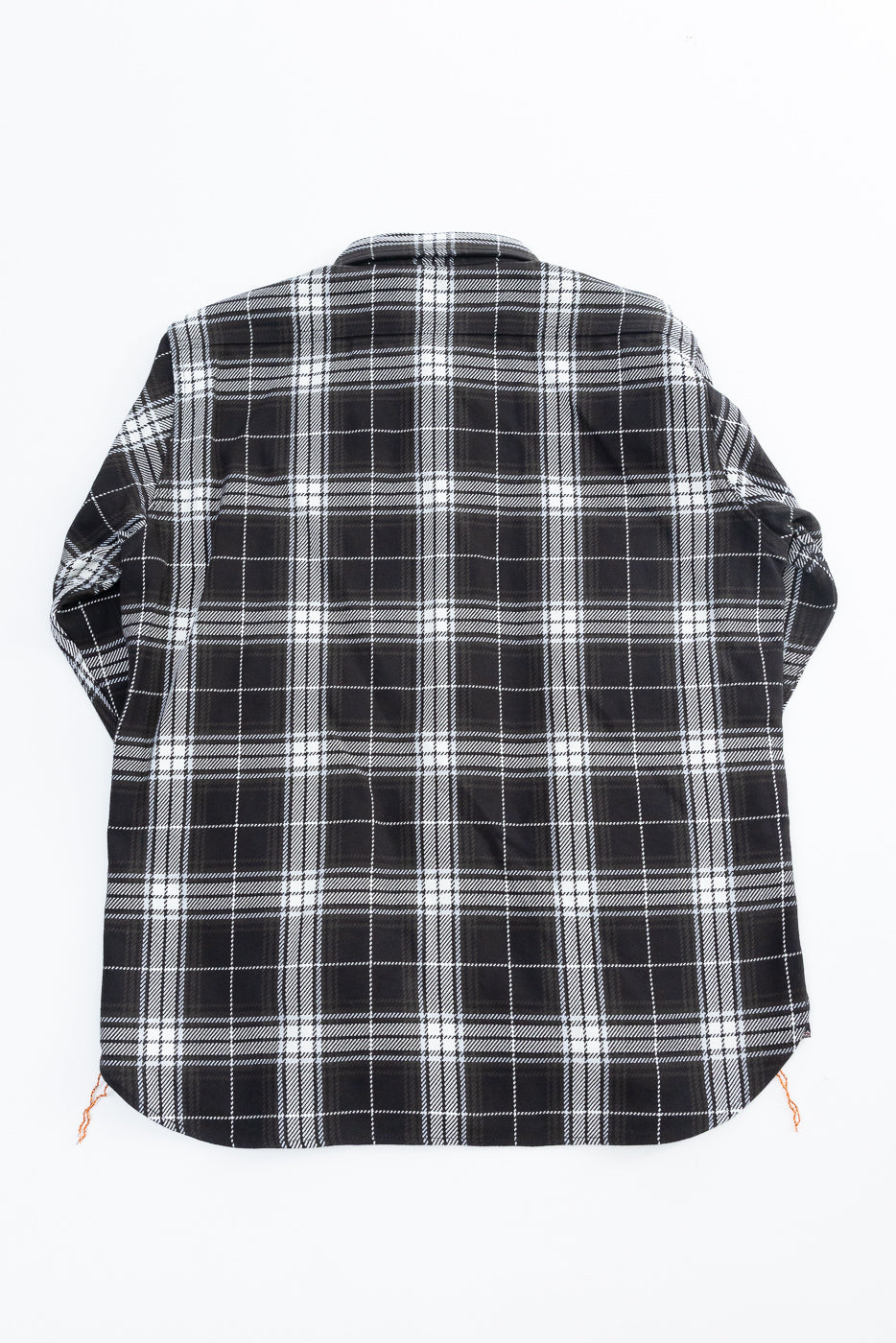 Flat lay, back view of black and white plaid selvedge flannel work shirt.