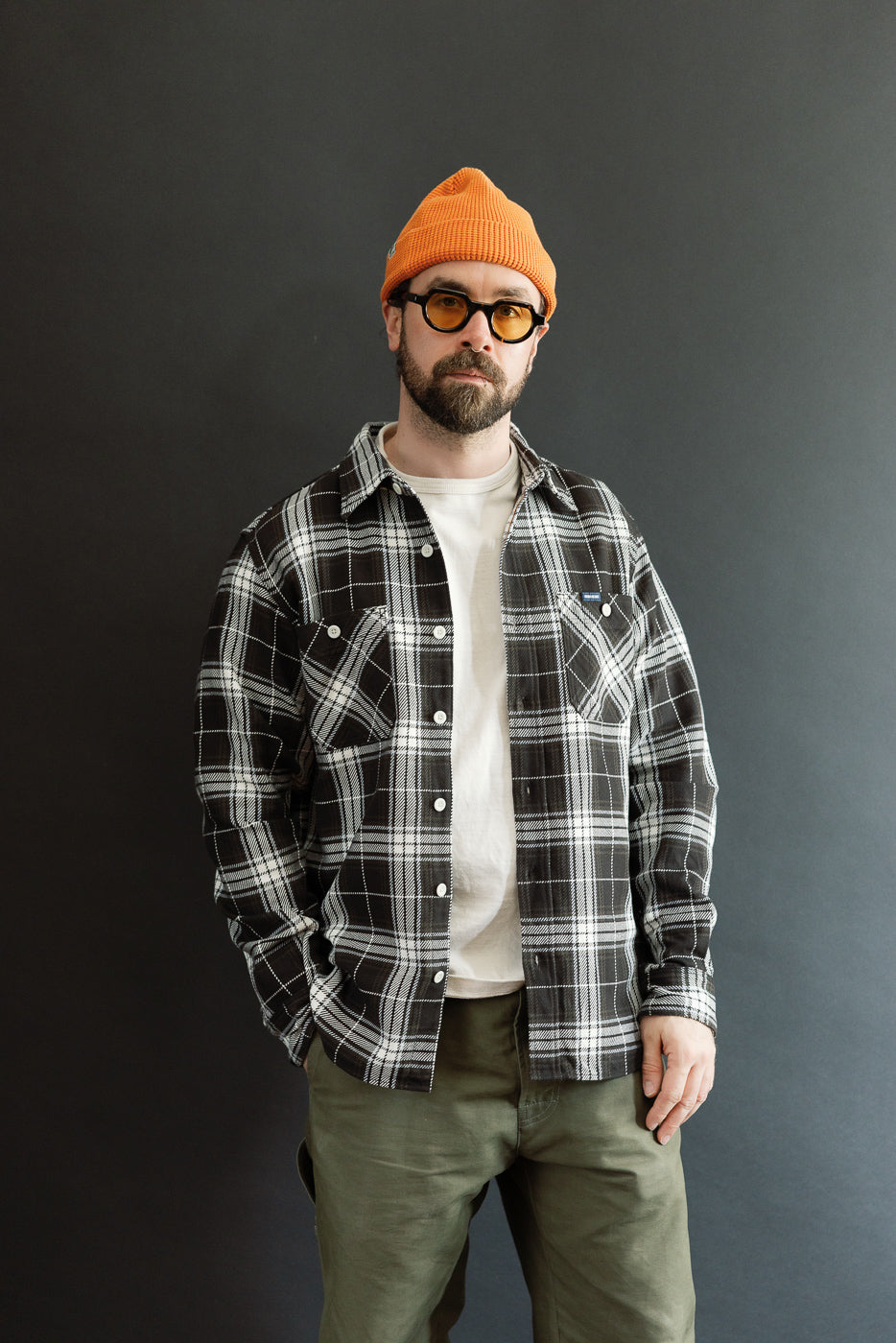 Front view, male model 5'9” 165lbs athletic build wearing black selvedge flannel work shirt