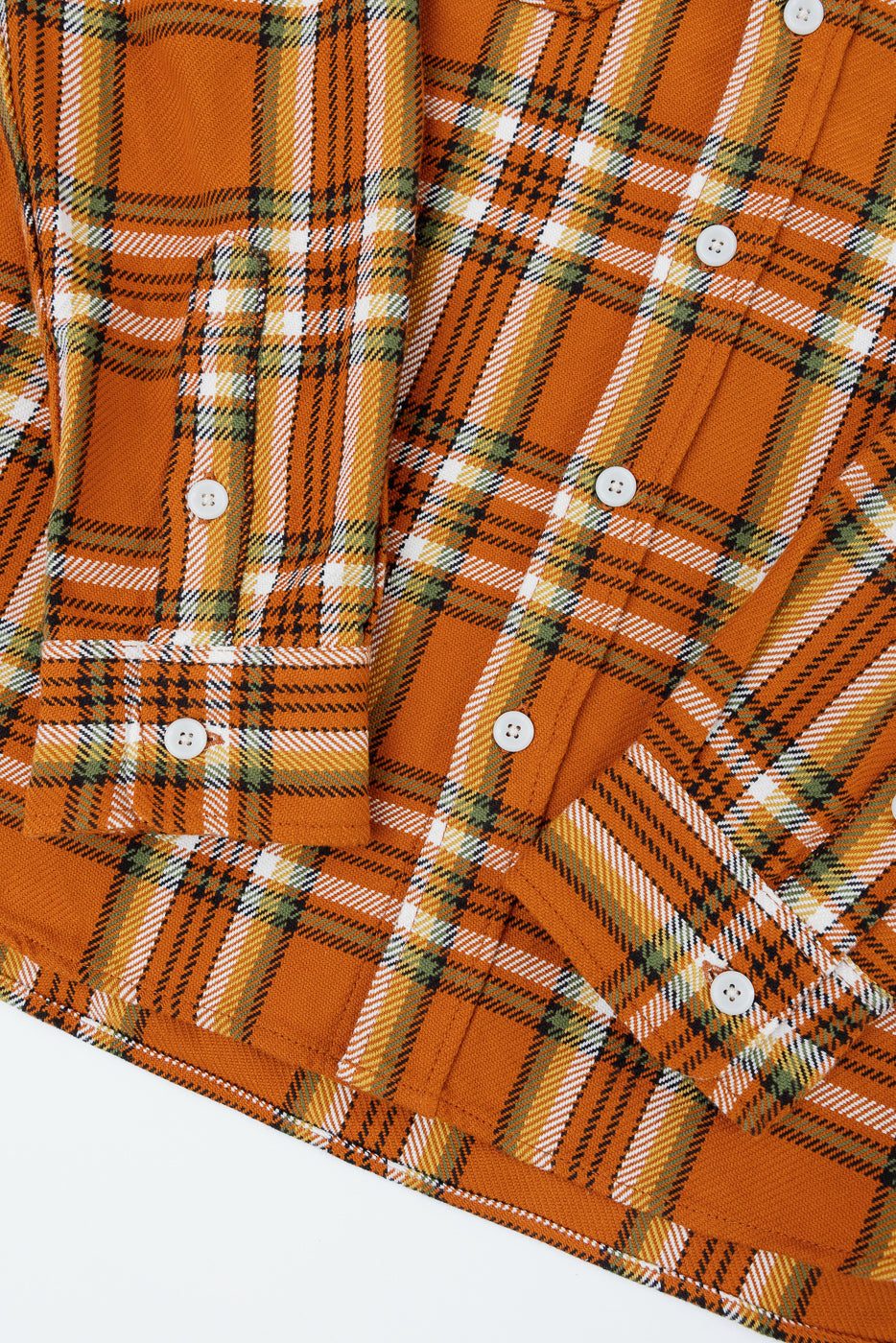 Close-up of orange plaid shirt front, showcasing buttons and fabric texture