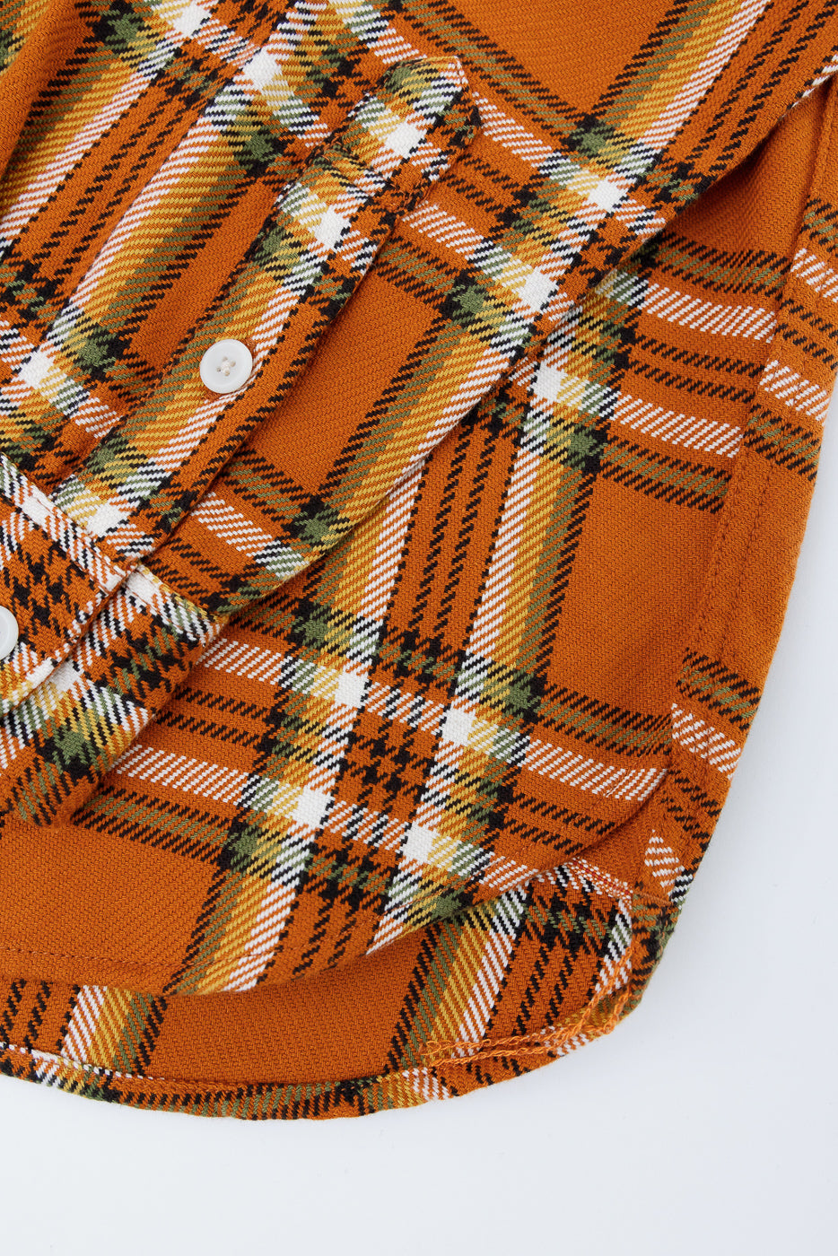 Close-up of orange plaid shirt front, showing button details and fabric texture