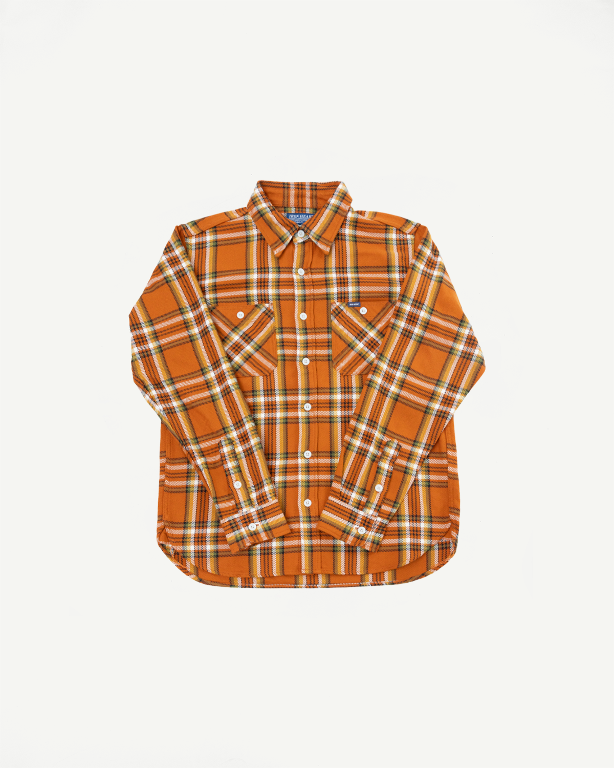 Front flat lay of orange plaid flannel shirt with button cuffs and chest pockets