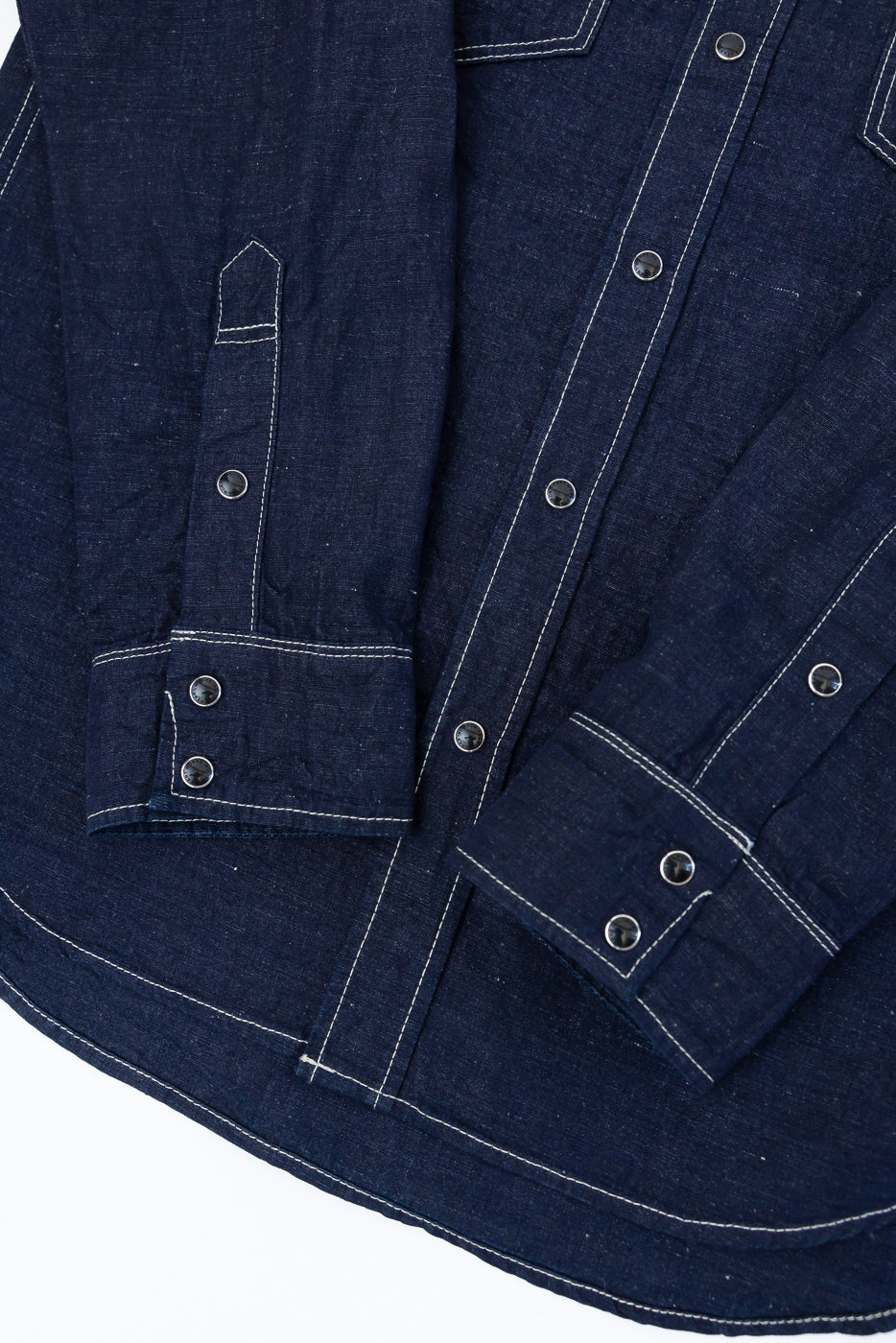 IHSH-444-IND - 7oz Cotton Linen Chambray Western Shirt in indigo, featuring white contrast stitching, snap-button cuffs, and flap-down chest pockets, showcasing meticulous Japanese craftsmanship and rugged elegance.