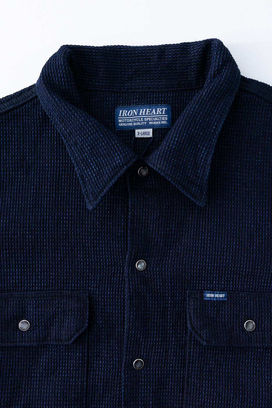 Close-up front view of navy waffle-textured shirt with collar, buttons, and chest pockets, size XL.