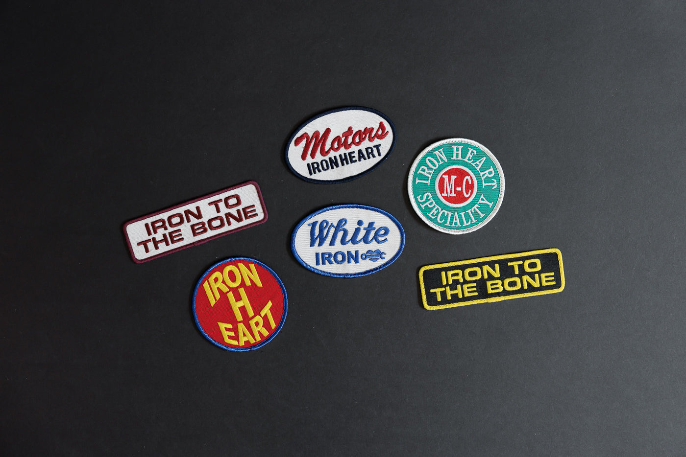 Iron Heart patches collection, front view, various designs and colors on black background