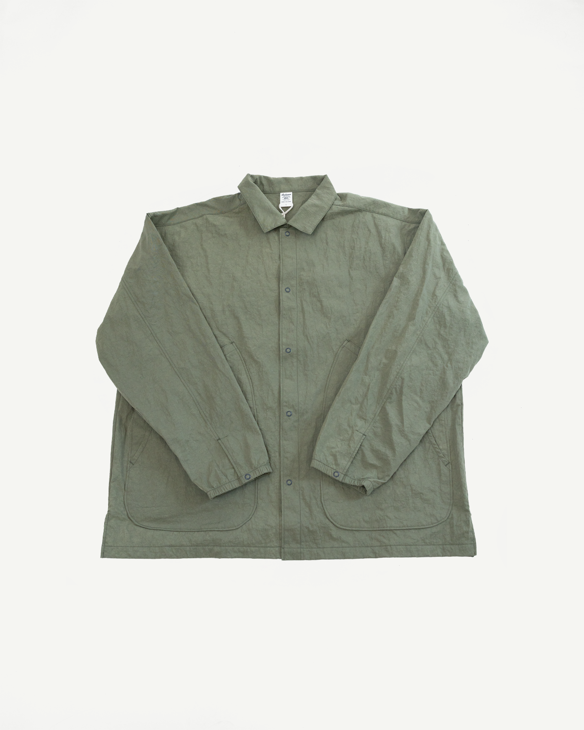 Front view flat lay of an olive green long-sleeve button-down shirt with patch pockets.