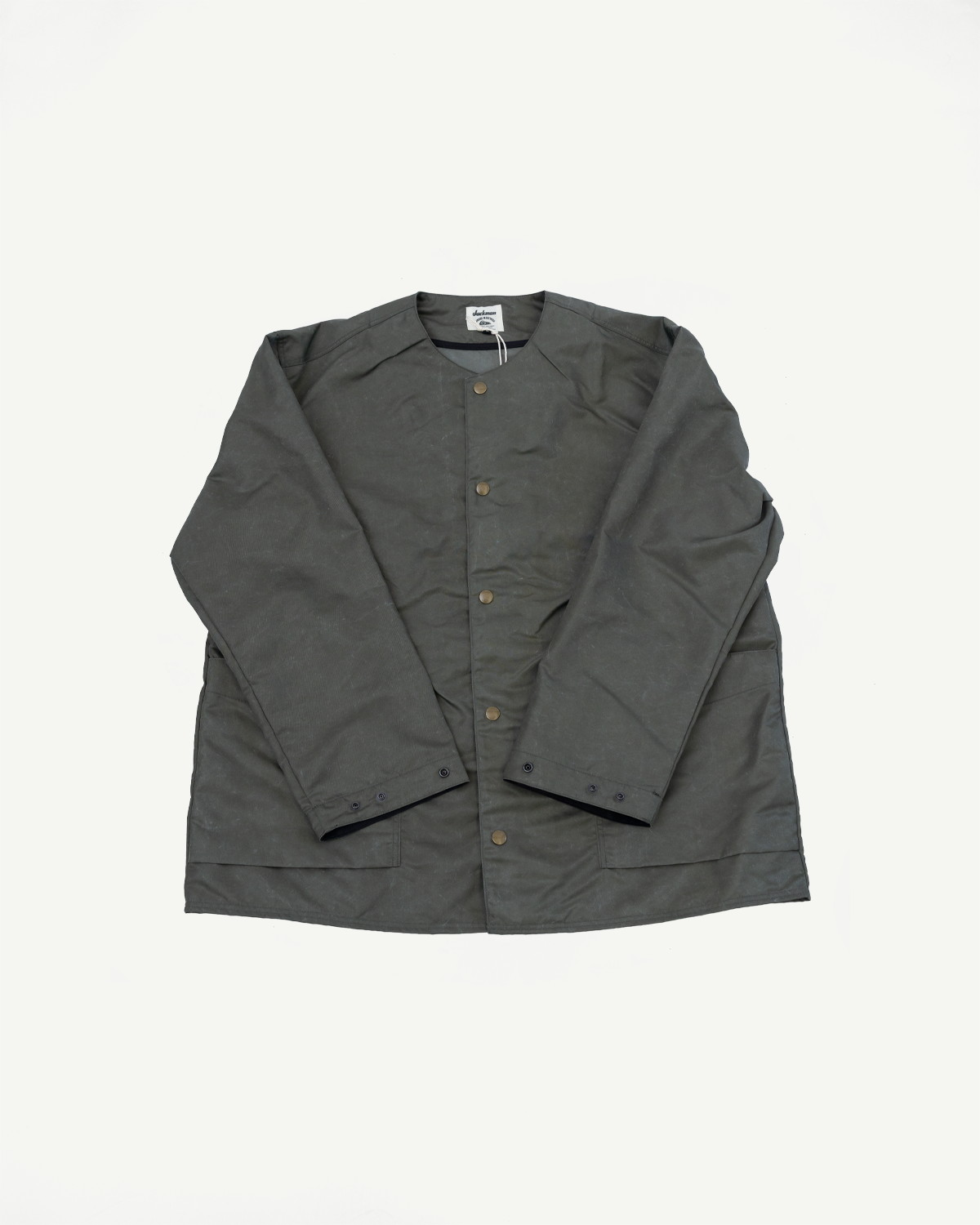 Flat lay front view olive collarless jacket, metal snap buttons, angled sleeves, pocket detail.