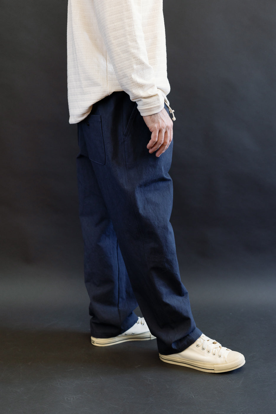 Side view of navy canvas pants on male model, 5'9