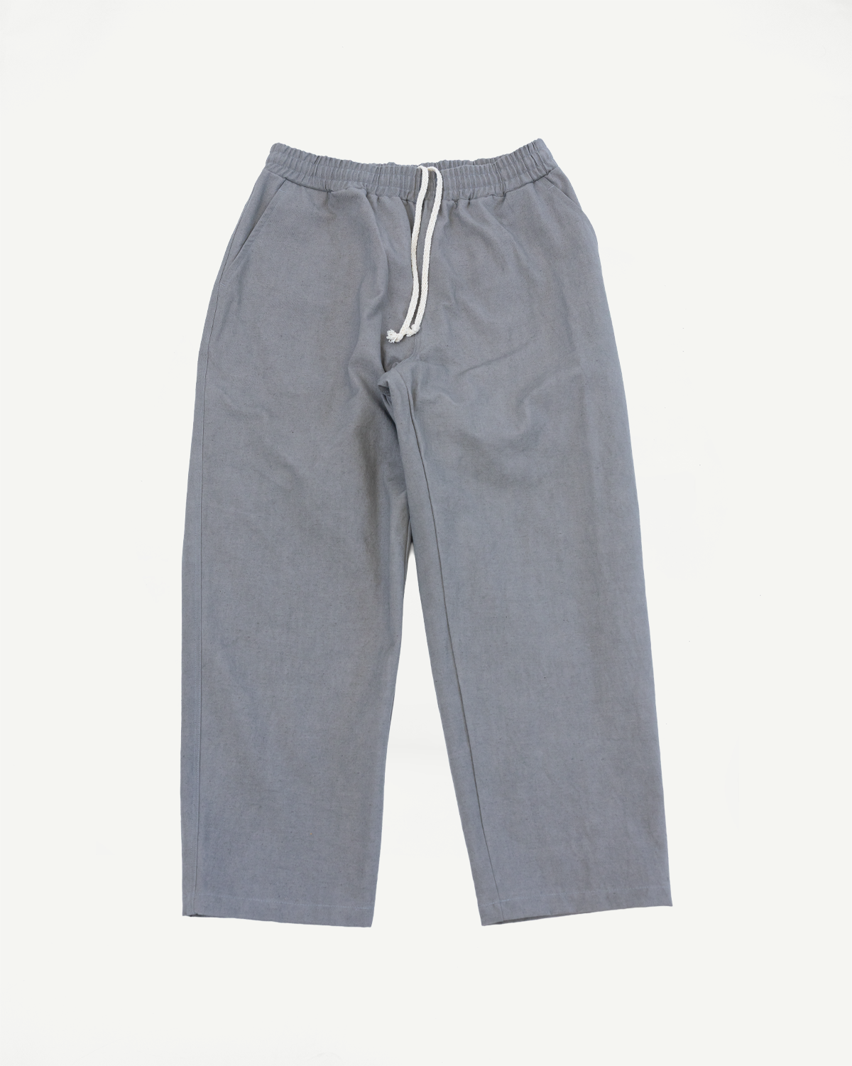 Flat lay front view of gray canvas rookie pants with elastic waist and white drawstring.