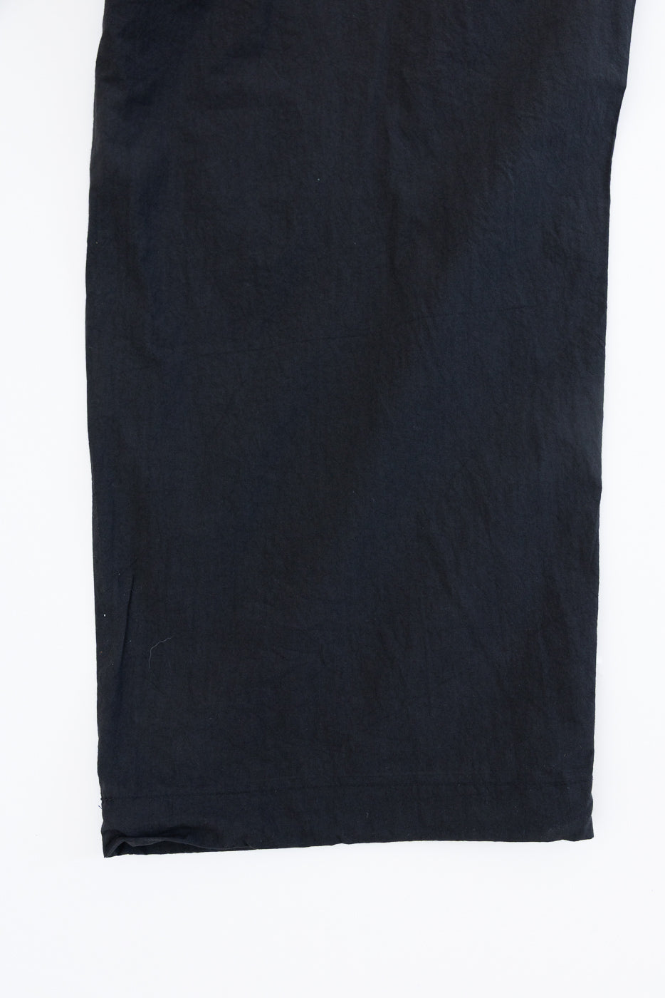 Flat lay front view of dark navy casual pants, showing hem detail and fabric texture