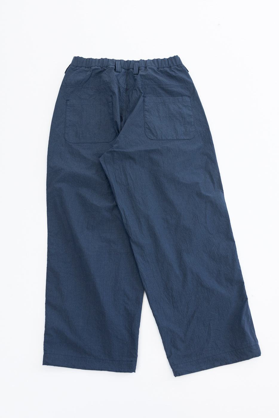 Back view flat lay of navy wide-leg casual pants with elastic waist, two rear pockets, and straight hem