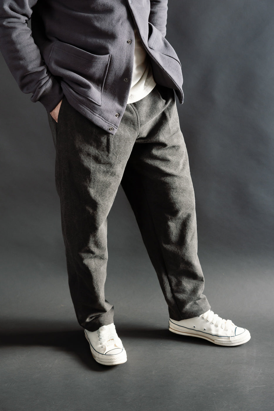 Front view cropped close-up of black casual pants on male model, 5'9