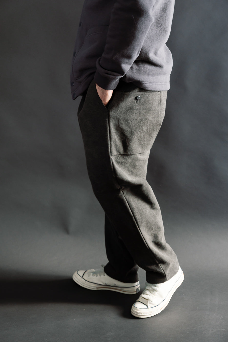 Side view of black casual pants on male model, 5'9