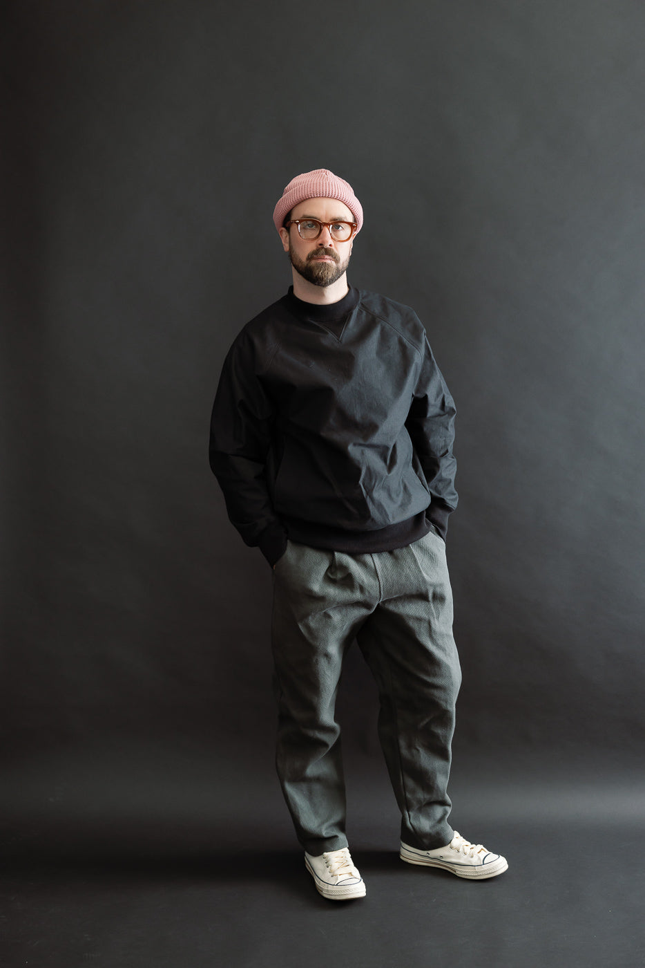 JM4623 - Sashiko Ump Pants - 333 Falcon Gray displayed on a 5'9 Caucasian male wearing a black pullover, pink beanie, and off-white sneakers, highlighting the pants' structured drape and umpire-inspired silhouette.