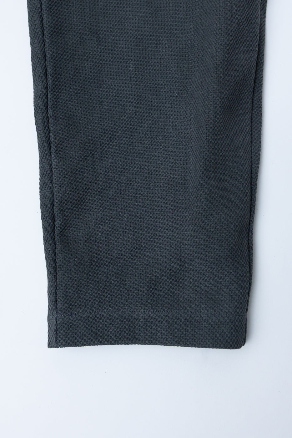 JM4623 - Sashiko Ump Pants - 333 Falcon Gray close-up of hem and side seam, showcasing the textured sashiko fabric's intricate weave and structured drape, highlighting its heritage-inspired design and craftsmanship.