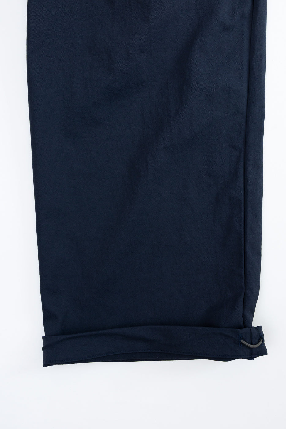Navy blue casual pants, close-up front view showing cuffed hem with drawstring detail, flat lay