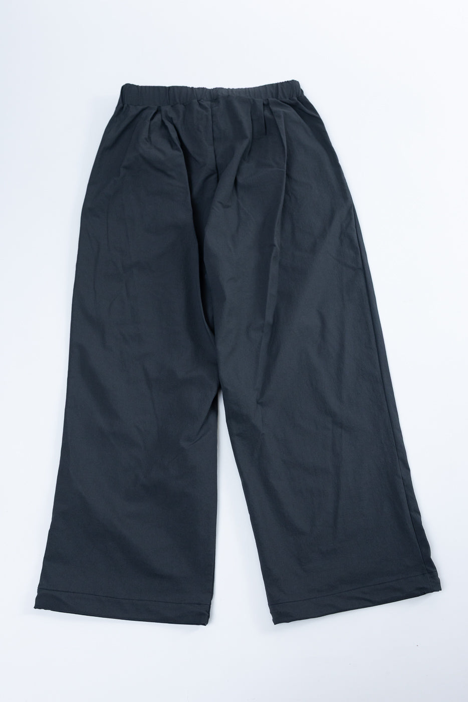 Flat lay front view of black wide-leg casual pants with elastic waistband and clean hem