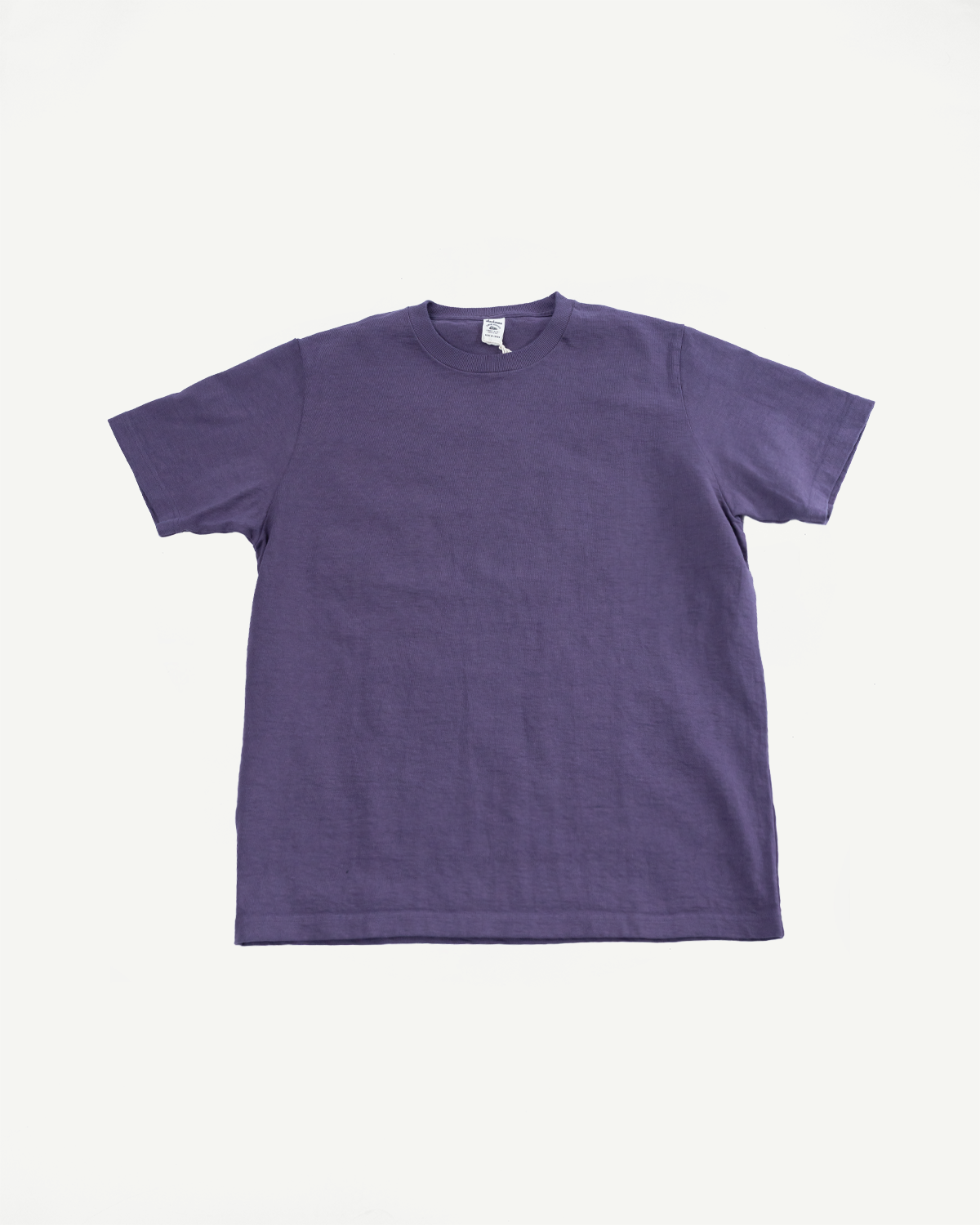 Purple ribbed crewneck t-shirt flat lay, front view, showing tag detail and short sleeves