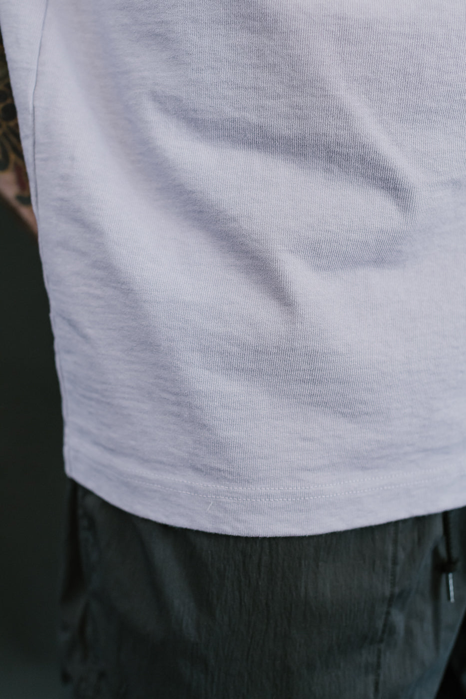 close up hem view of person wearing a light purple shirt