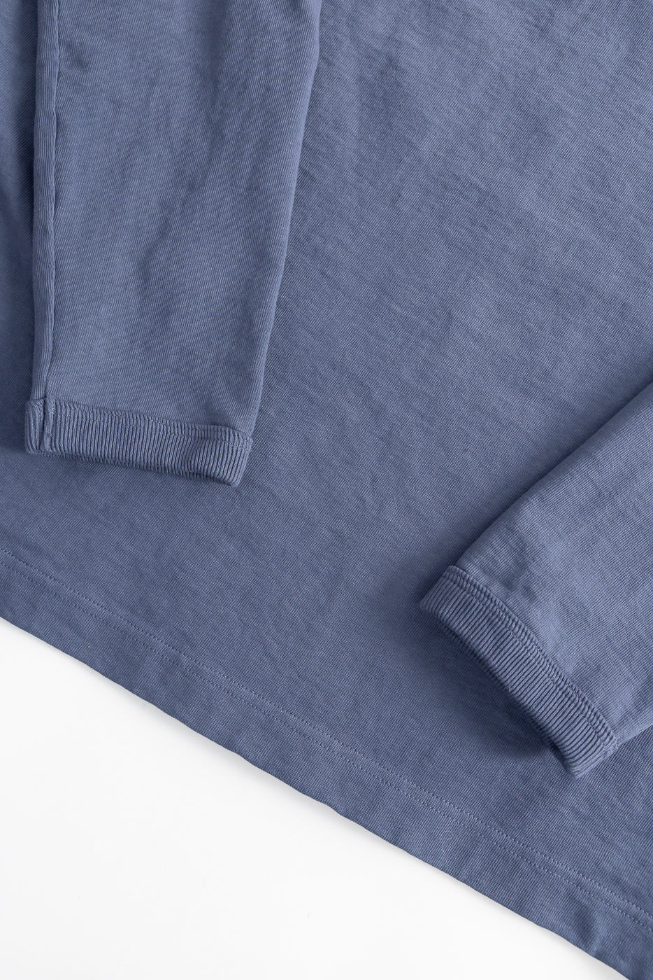 Close-up of classic navy Jackman long sleeve T-shirt, front hem and ribbed cuffs detail