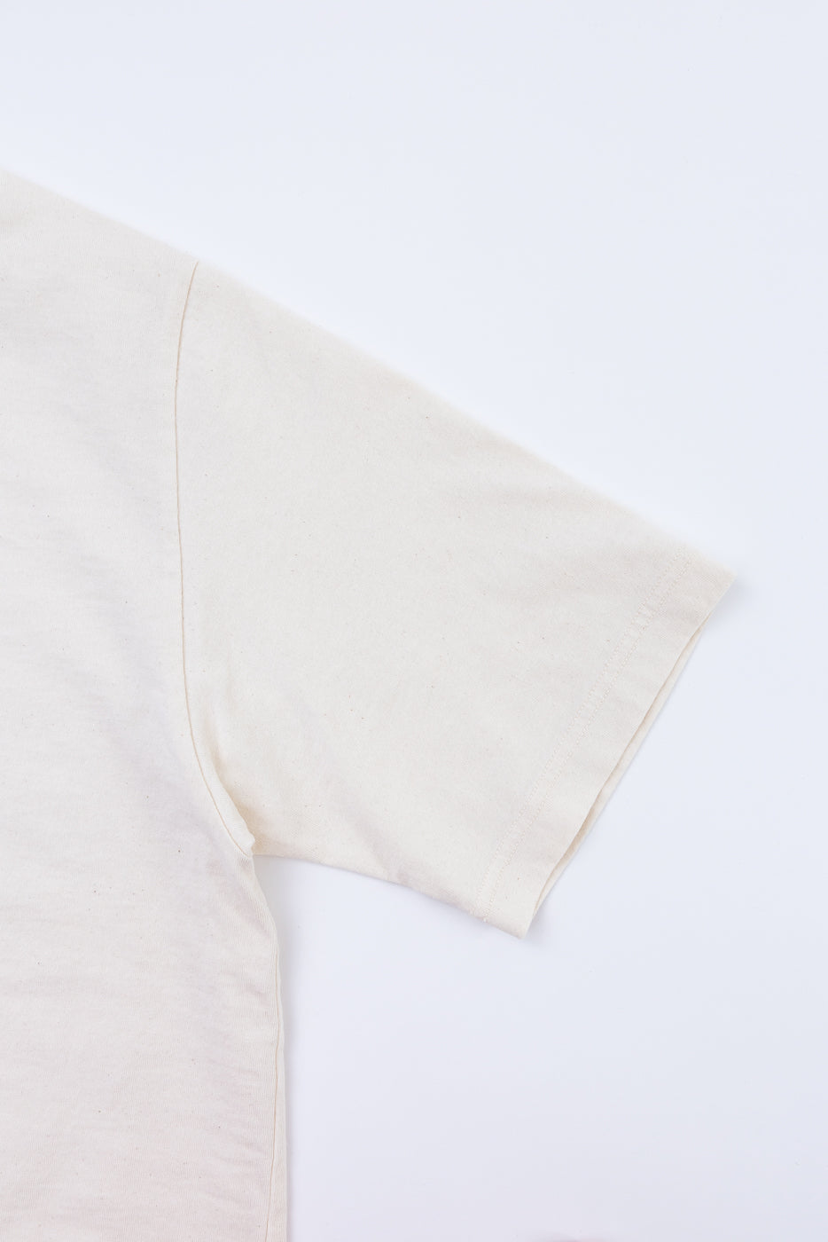 Close-up of a white shirt with a beige collar on a white background