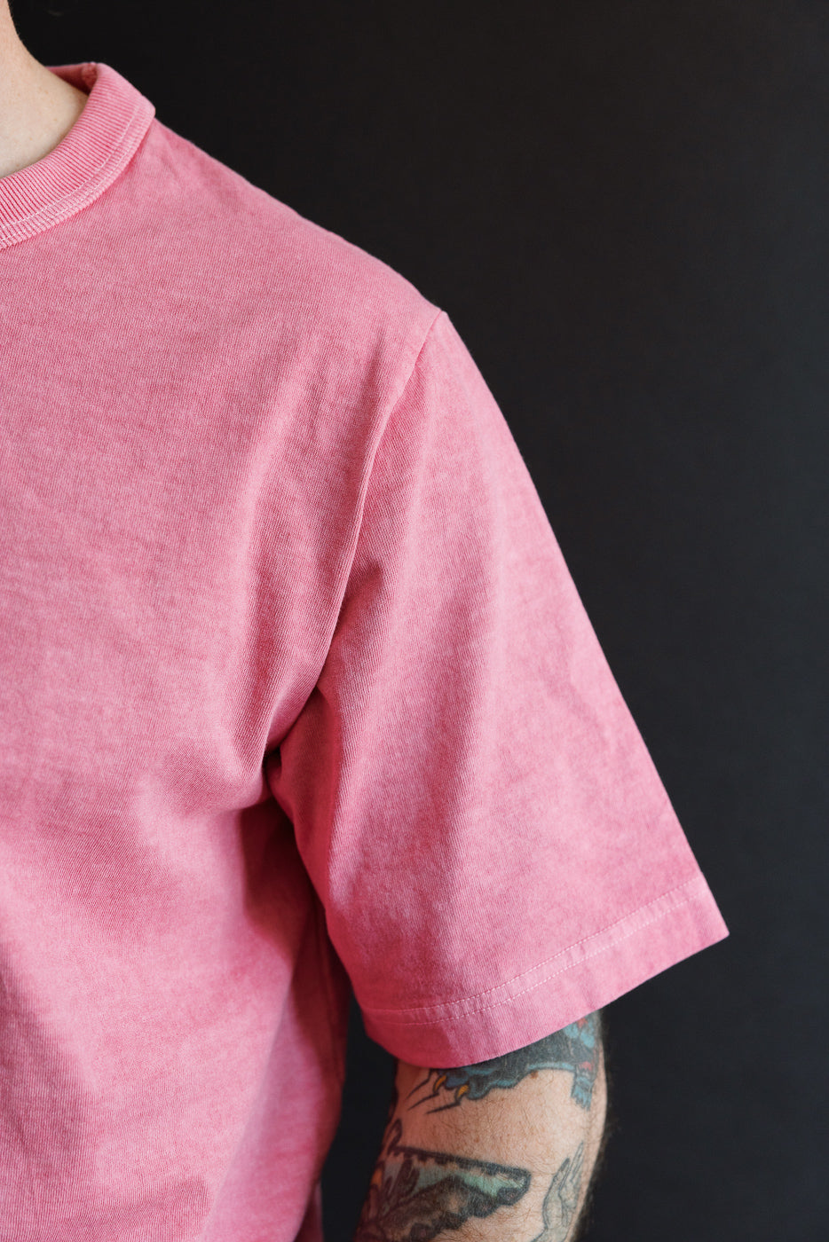 Close-up front view of pink short-sleeve tee, male model 5'9