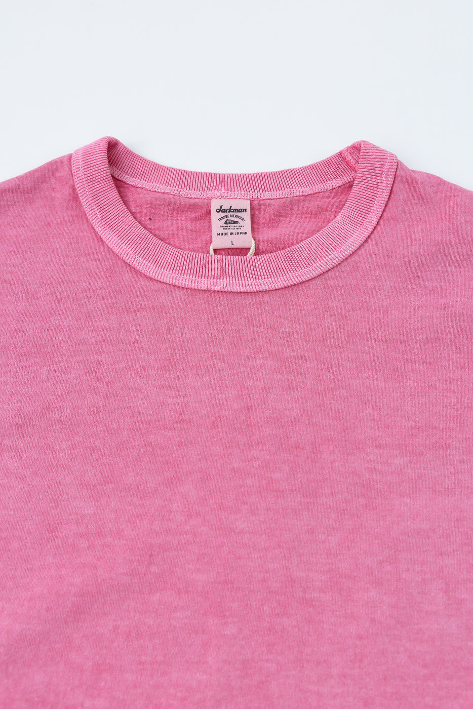 Pink crew neck tee, front close-up showing ribbed collar & Jackman tag, made in Japan