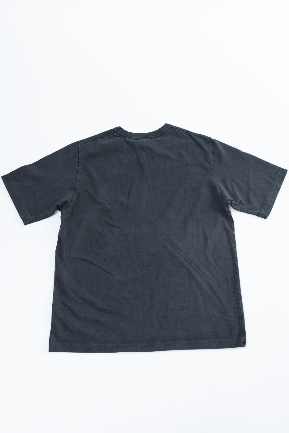 Back view of dark gray short-sleeve t-shirt, flat lay, showing hem and ribbed collar